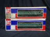 pair of green and red train cars sitting on top of each other