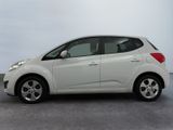 a picture of a small white car parked in a parking lot