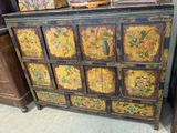 a wooden cabinet with many drawers and a basket on top of it