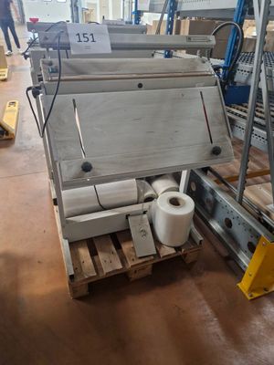 several rolls of toilet paper sit on a pallet in a warehouse