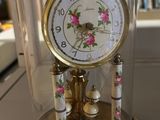 a clock inside of a glass dome on a table