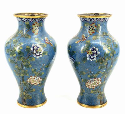pair of blue vases with flowers and birds on them on a white background