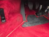 red carpet in a car with black trims and red floor mats