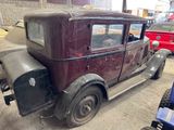 a old car that is parked in a garage