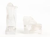 two pieces of ice sitting next to each other on a white surface