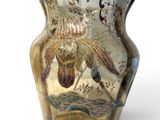 a glass vase with a painting on it on a white surface