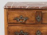 a marble top chest of drawers with a marble top
