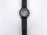 a close up of a wrist watch on a white surface