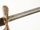 a close up of a sword with a writing on it