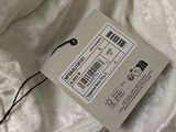 a close up of a white shirt with a tag attached to it