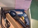 a box with a drill and a cord in it