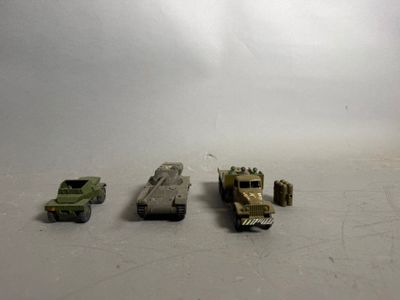 several toy vehicles are lined up in a row on a white surface