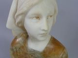 marble bust of a woman with a veil on her head