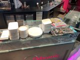 many plates and cups on the counter of a restaurant