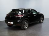the rear end of a black suv parked in a room