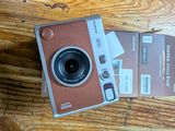 a small camera sitting on top of a table next to a card