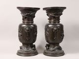 two vases that are sitting next to each other on a table