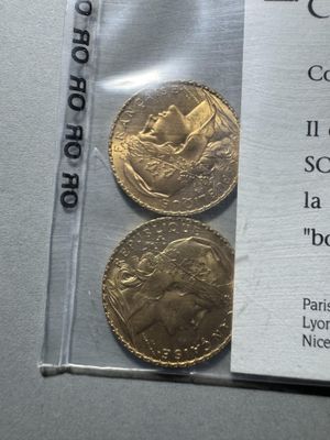 two gold coins in a clear plastic bag on a table