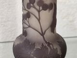 a glass vase with a design on it on a glass table