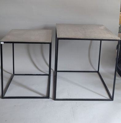 pair of concrete side tables with black metal bases