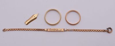 a close up of a gold bracelet with two rings and a pair of scissors