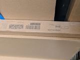 a cardboard box with a blue ribbon on top of it