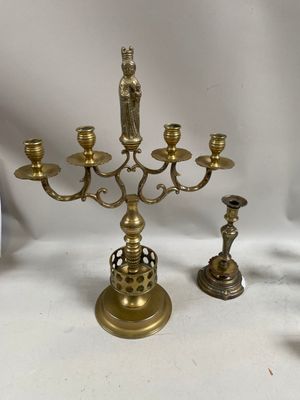a brass candelab with a figurine on top of it