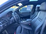 the interior of a car with black leather seats and dashboard controls