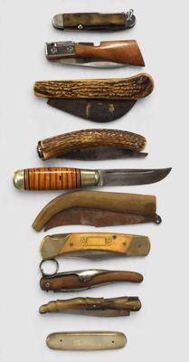 many different types of knives on a white surface