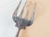 a metal fork that is sitting on a table