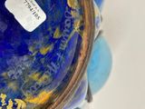 a close up of a blue vase with a tag on it