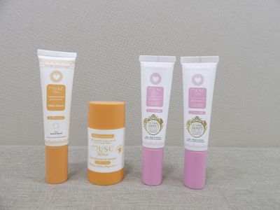 three different types of sunscreen creams and a tube of sunscreen cream