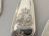 a silver spoon and two silver spoons on a table