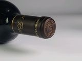 a bottle of wine that is sitting on a table