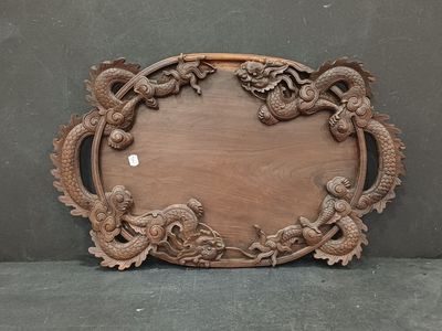 a picture of a wooden plaque with a dragon design on it