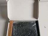 a white box with a small amount of beads inside of it