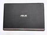 the back of a laptop with a black cover on a white surface