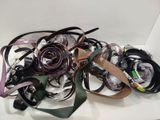 a lot of belts that are laying on a table