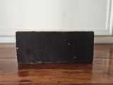 a black block sitting on a wooden table