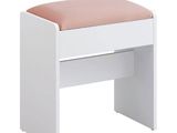 a white bench with a pink cushion on top of it