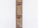 an old book that is sitting on a white surface
