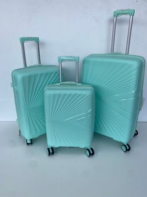three pieces of luggage sitting on top of a white surface