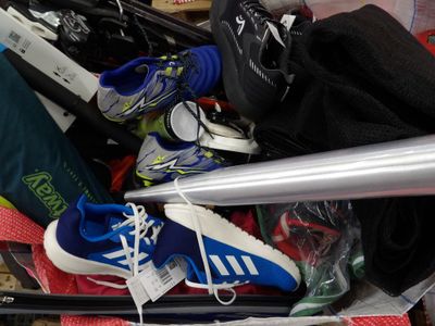 a pile of skis and other sports equipment in a suitcase