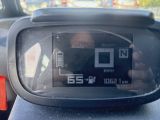 a close up of a car ' s dashboard with a person taking a picture