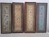 four framed pictures of oriental designs on a table