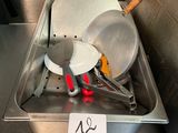 a metal tray with a bunch of cooking utensils on it
