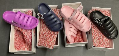 three pairs of shoes are in a box on a table
