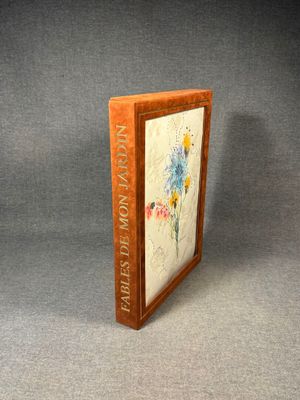 an old book with a picture of a flower on it