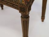a close up of a chair with a colorful upholstered seat