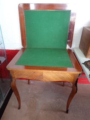 a small table with a green cushion on it